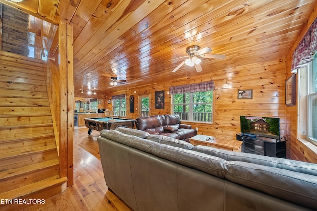 living room featuring pool table, ceiling fan, wooden walls, light wood finished floors, and wood ceiling
