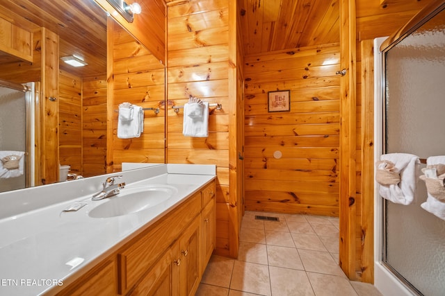 bathroom with wooden ceiling, wood walls, a shower stall, tile patterned floors, and vanity