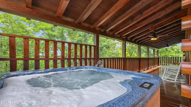 wooden terrace featuring a hot tub