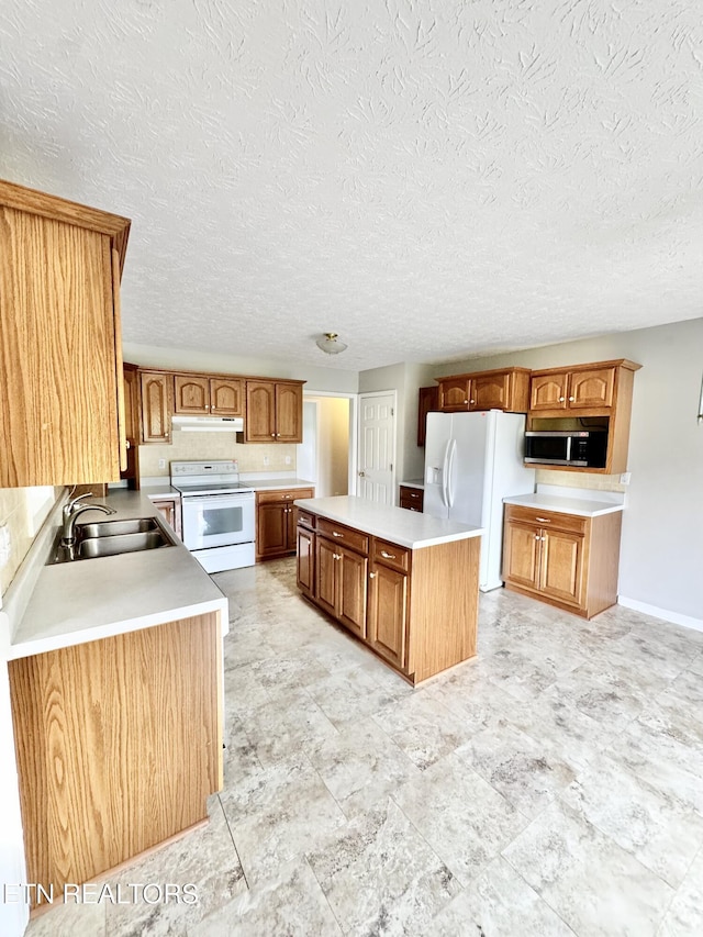 200 Harmon Cir, New Tazewell, TN 37825 - kitchen with white appliances, under cabinet range hood, a sink, a center island, and brown cabinets