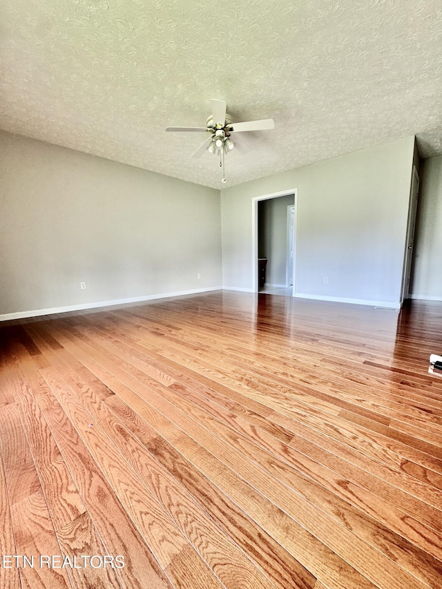 200 Harmon Cir, New Tazewell, TN 37825 - unfurnished room featuring wood finished floors, baseboards, a ceiling fan, and a textured ceiling