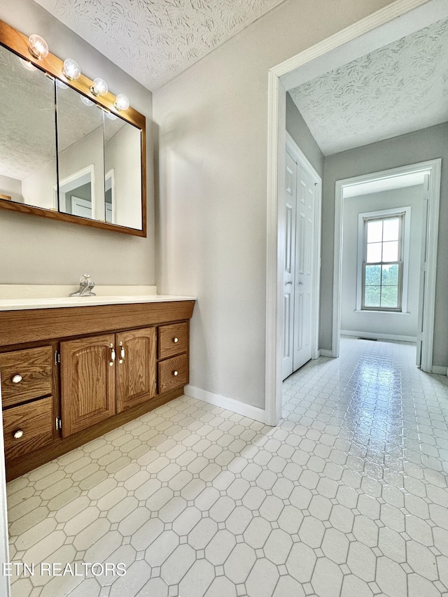 200 Harmon Cir, New Tazewell, TN 37825 - bathroom with a textured ceiling, baseboards, vanity, and tile patterned floors