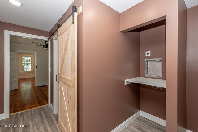 1431 Remsen St, Alcoa, TN 37701 - hallway with wood finished floors, a barn door, and baseboards