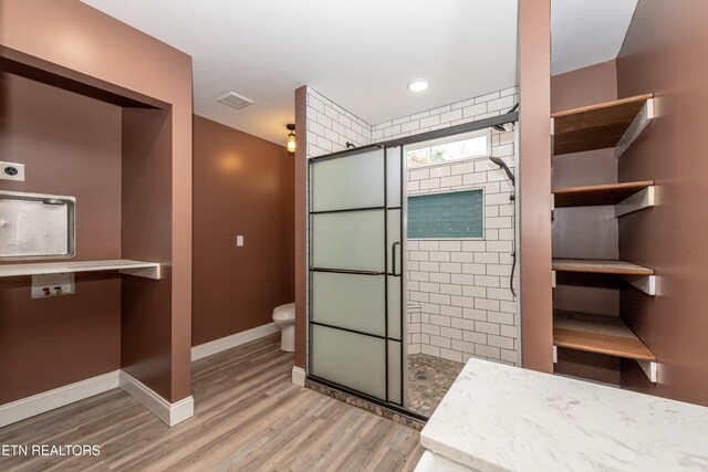1431 Remsen St, Alcoa, TN 37701 - bathroom featuring a stall shower, wood finished floors, and toilet