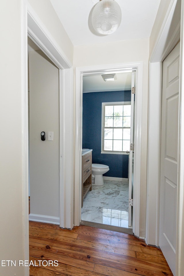 1431 Remsen St, Alcoa, TN 37701 - bathroom featuring toilet, baseboards, wood finished floors, and vanity