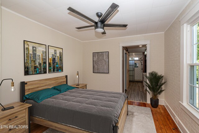 1431 Remsen St, Alcoa, TN 37701 - bedroom with hardwood / wood-style floors, crown molding, brick wall, and ceiling fan
