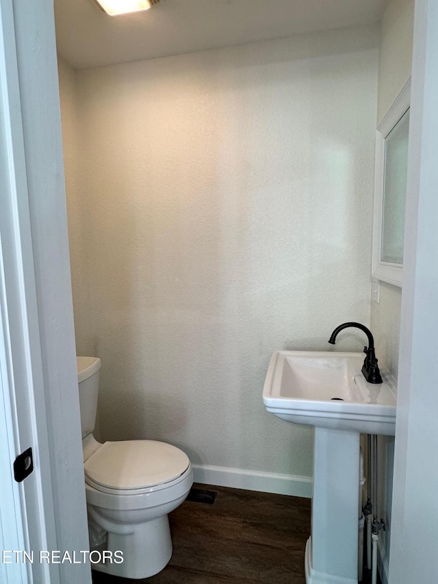 4540 S York Hwy, Jamestown, TN 38556 - bathroom featuring wood finished floors, baseboards, toilet, and a sink