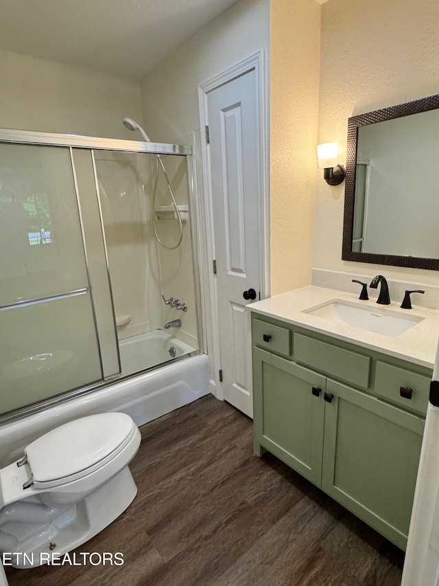 4540 S York Hwy, Jamestown, TN 38556 - full bathroom with toilet, wood finished floors, vanity, combined bath / shower with glass door, and a textured wall