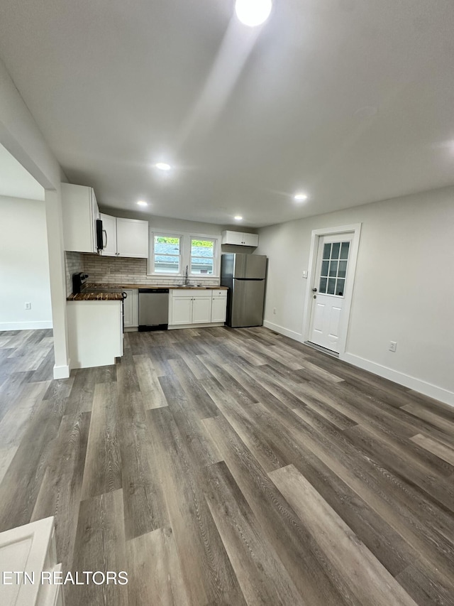 3824 Catalpa Ave, Knoxville, TN 37914 - kitchen with appliances with stainless steel finishes, dark countertops, dark wood-type flooring, baseboards, and recessed lighting