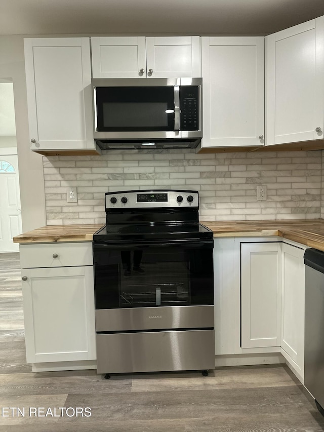 3824 Catalpa Ave, Knoxville, TN 37914 - kitchen with wooden counters, appliances with stainless steel finishes, light wood finished floors, and white cabinetry