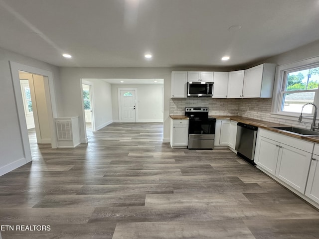 3824 Catalpa Ave, Knoxville, TN 37914 - kitchen with appliances with stainless steel finishes, a sink, tasteful backsplash, recessed lighting, and white cabinetry