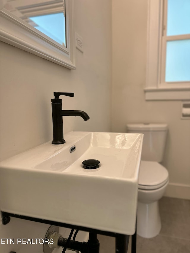 3824 Catalpa Ave, Knoxville, TN 37914 - half bathroom featuring a sink, toilet, tile patterned flooring, and healthy amount of natural light