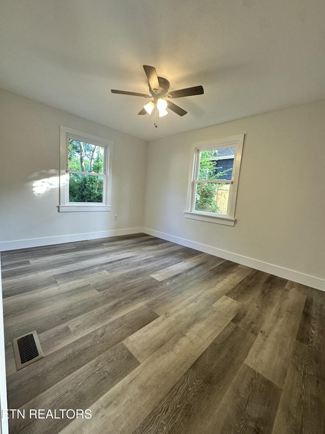 3824 Catalpa Ave, Knoxville, TN 37914 - empty room with dark wood-type flooring, a ceiling fan, and baseboards