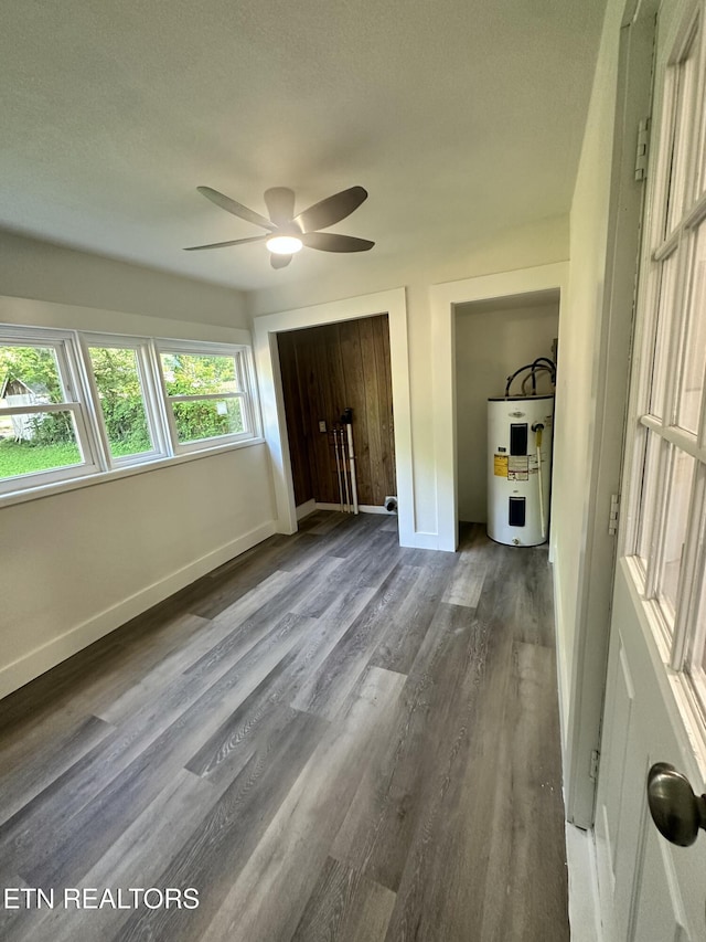 3824 Catalpa Ave, Knoxville, TN 37914 - unfurnished bedroom with electric water heater, wood finished floors, baseboards, a ceiling fan, and a textured ceiling