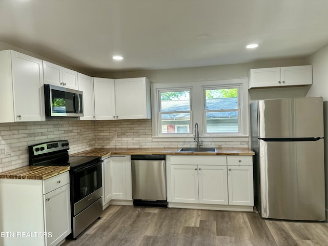 3824 Catalpa Ave, Knoxville, TN 37914 - kitchen featuring stainless steel appliances, butcher block countertops, a sink, decorative backsplash, and recessed lighting