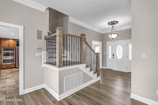117 Mayview Dr, Powell, TN 37849 - entryway featuring baseboards, stairway, ornamental molding, and wood finished floors
