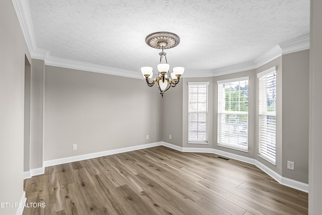 117 Mayview Dr, Powell, TN 37849 - empty room with a chandelier, wood finished floors, a textured ceiling, baseboards, and crown molding
