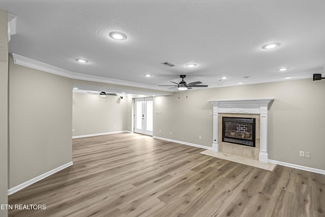 117 Mayview Dr, Powell, TN 37849 - unfurnished living room featuring ceiling fan, ornamental molding, wood finished floors, a tiled fireplace, and baseboards