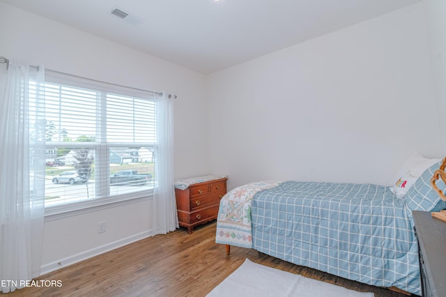 548 Cliff St, Morristown, TN 37814 - bedroom with multiple windows, light wood finished floors, and baseboards