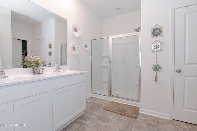 548 Cliff St, Morristown, TN 37814 - full bathroom featuring a stall shower, double vanity, and baseboards