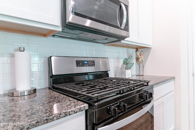 548 Cliff St, Morristown, TN 37814 - kitchen featuring gas range oven, stainless steel microwave, tasteful backsplash, and white cabinets