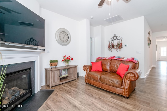 548 Cliff St, Morristown, TN 37814 - living room featuring ceiling fan, wood finished floors, a glass covered fireplace, and baseboards