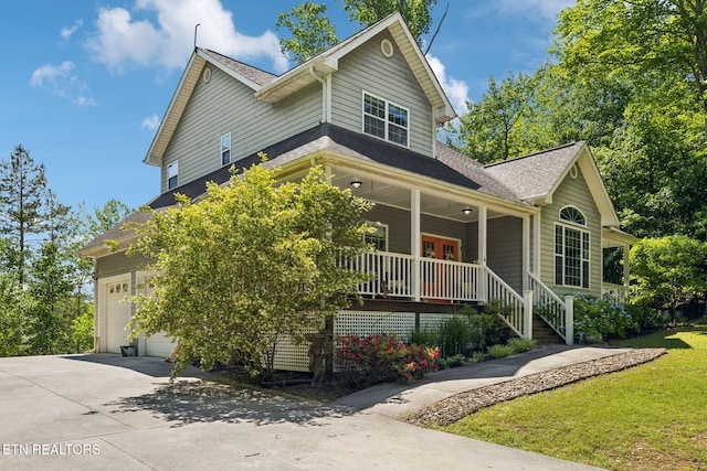 221 Stony Rock Ln, Jacksboro, TN 37757 - view of front facade featuring covered porch, driveway, a shingled roof, and a front lawn