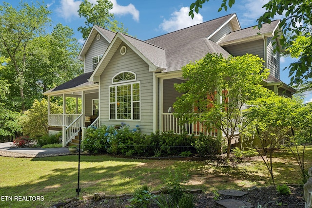 221 Stony Rock Ln, Jacksboro, TN 37757 - view of front of house with covered porch, a front yard, and roof with shingles