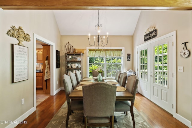 221 Stony Rock Ln, Jacksboro, TN 37757 - dining room featuring lofted ceiling, a chandelier, healthy amount of natural light, wood finished floors, and baseboards
