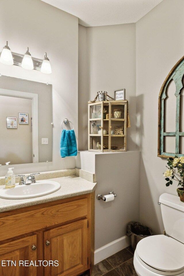 221 Stony Rock Ln, Jacksboro, TN 37757 - bathroom featuring toilet, vanity, and baseboards