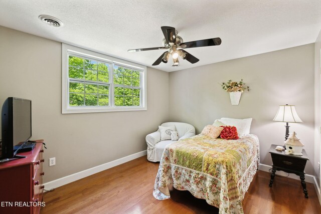 221 Stony Rock Ln, Jacksboro, TN 37757 - bedroom with baseboards, wood finished floors, ceiling fan, and a textured ceiling