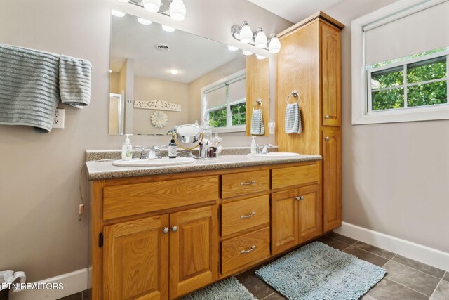221 Stony Rock Ln, Jacksboro, TN 37757 - bathroom with double vanity, baseboards, and tile patterned floors