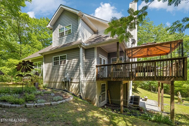 221 Stony Rock Ln, Jacksboro, TN 37757 - view of home's exterior featuring a deck, a lawn, and central air condition unit