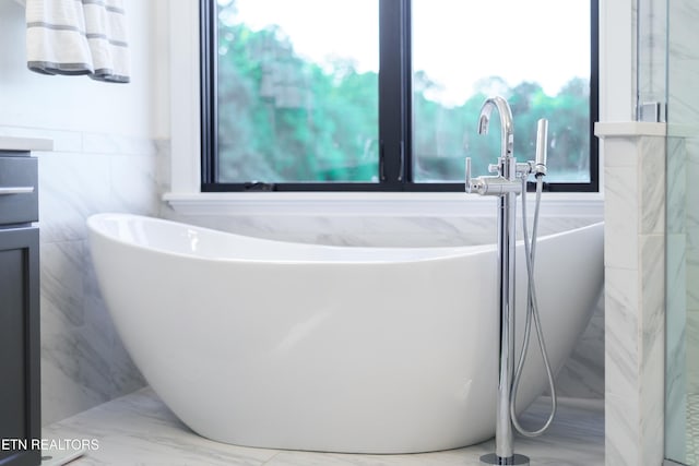 8539 N Ruggles Ferry Pike, Strawberry Plains, TN 37871 - bathroom featuring tile walls and a soaking tub
