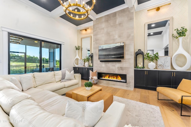 8539 N Ruggles Ferry Pike, Strawberry Plains, TN 37871 - living room with a towering ceiling, a chandelier, light wood-type flooring, ornamental molding, and a fireplace