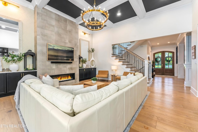 8539 N Ruggles Ferry Pike, Strawberry Plains, TN 37871 - living area featuring stairway, crown molding, a tile fireplace, coffered ceiling, and a chandelier