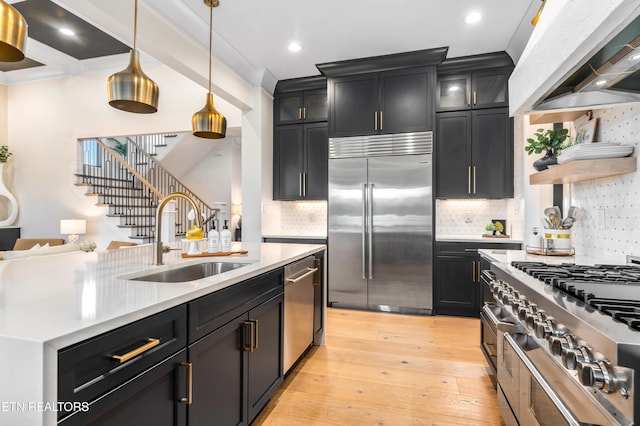 8539 N Ruggles Ferry Pike, Strawberry Plains, TN 37871 - kitchen featuring premium appliances, a sink, ventilation hood, dark cabinetry, and light countertops