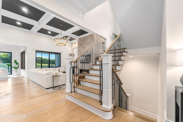 8539 N Ruggles Ferry Pike, Strawberry Plains, TN 37871 - stairs featuring a towering ceiling, coffered ceiling, wood finished floors, beam ceiling, and a chandelier