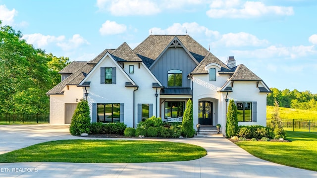 8539 N Ruggles Ferry Pike, Strawberry Plains, TN 37871 - french country inspired facade featuring driveway, a chimney, board and batten siding, brick siding, and a garage