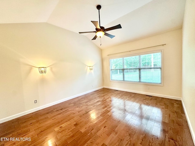 129 Canary Ct, Crossville, TN 38555 - empty room with vaulted ceiling, a ceiling fan, wood finished floors, and baseboards