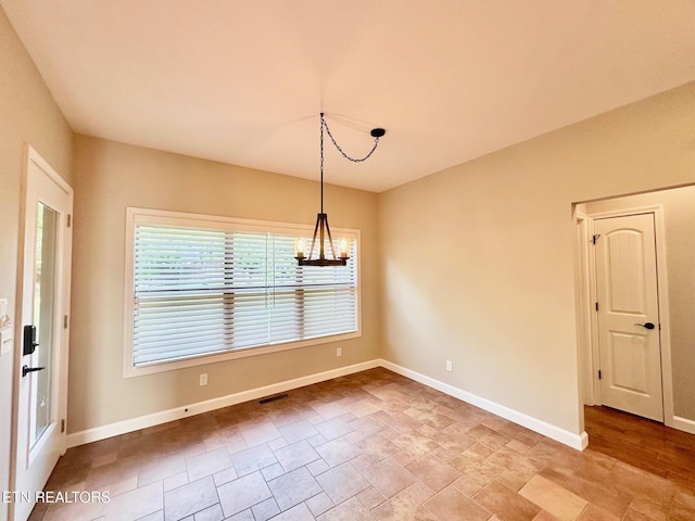 129 Canary Ct, Crossville, TN 38555 - unfurnished room featuring a chandelier, stone finish flooring, and baseboards