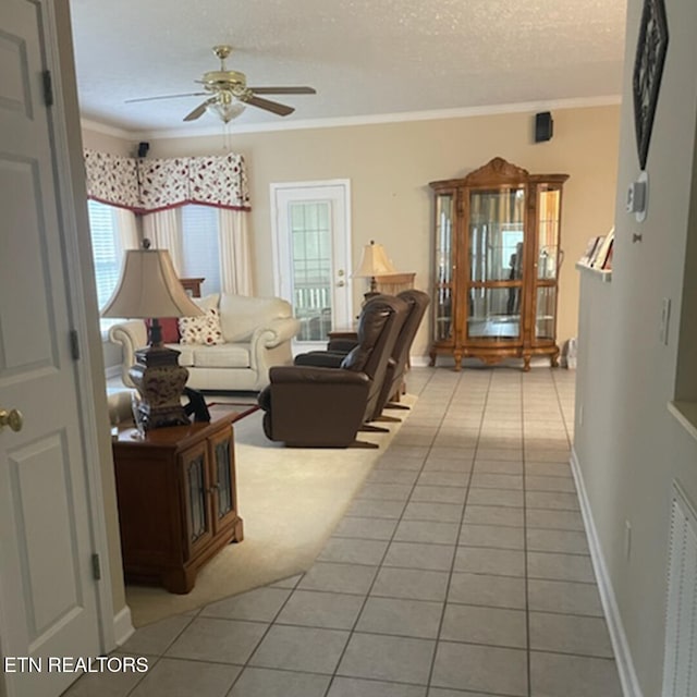 203 Hawthorn Loop, Crossville, TN 38555 - living room with tile patterned flooring, a ceiling fan, crown molding, a textured ceiling, and baseboards