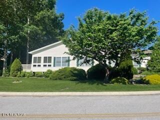 203 Hawthorn Loop, Crossville, TN 38555 - view of home's exterior featuring a yard