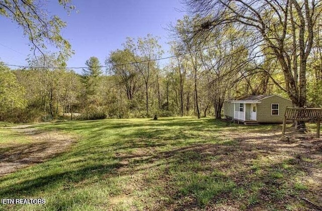 12863 Summer City Rd, Spring City, TN 37381 - view of grassy yard featuring an outdoor structure, a view of trees, and a deck