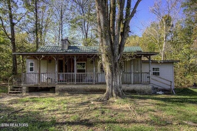 12863 Summer City Rd, Spring City, TN 37381 - view of front facade featuring covered porch, metal roof, and a front yard