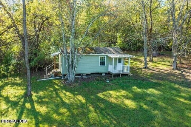 12863 Summer City Rd, Spring City, TN 37381 - view of property exterior featuring a wooded view, a lawn, and a wooden deck