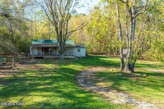 12863 Summer City Rd, Spring City, TN 37381 - view of grassy yard with a view of trees and covered porch