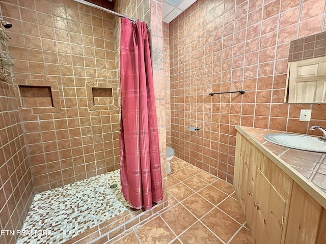 189 Bridle Way, Speedwell, TN 37870 - bathroom with tile walls, a tile shower, vanity, tile patterned flooring, and toilet