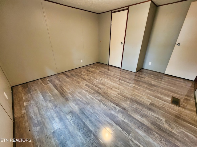 334 Corrington Ln, Lafollette, TN 37766 - unfurnished bedroom with wood finished floors and a textured ceiling