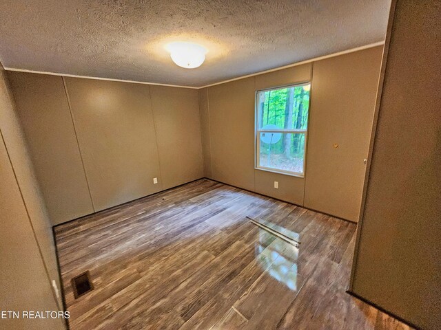 334 Corrington Ln, Lafollette, TN 37766 - spare room with wood finished floors, a textured ceiling, and crown molding